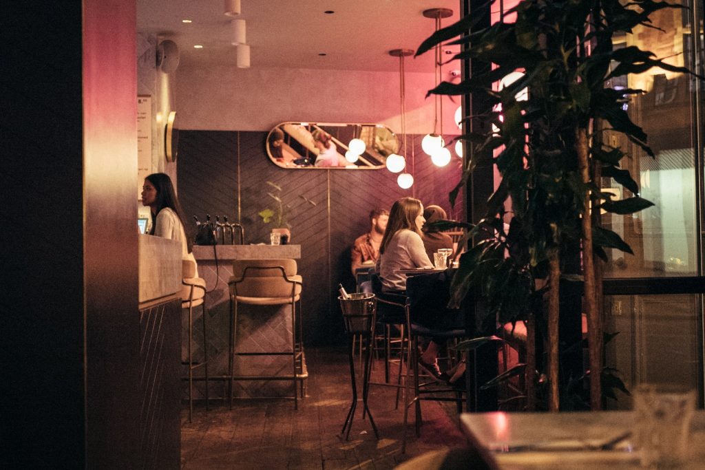 a group of people sitting at a table in a restaurant