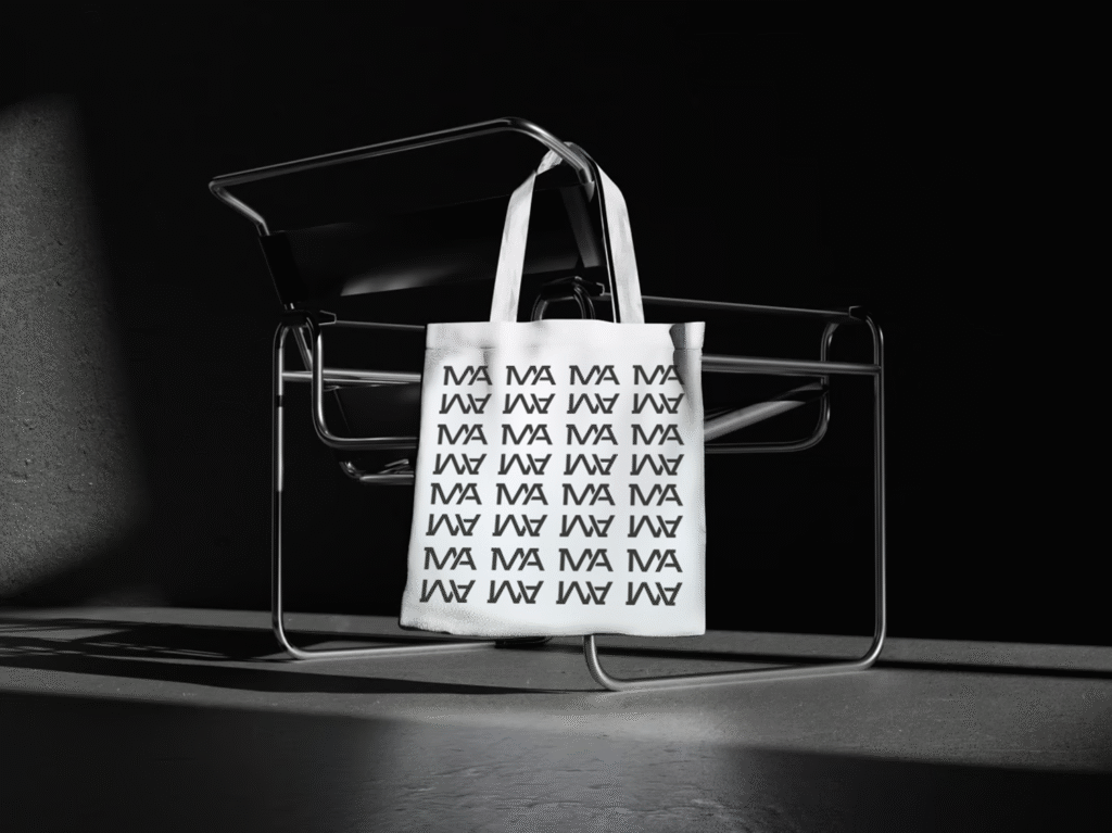 Tote bag with an MA monogram pattern resting on a chair